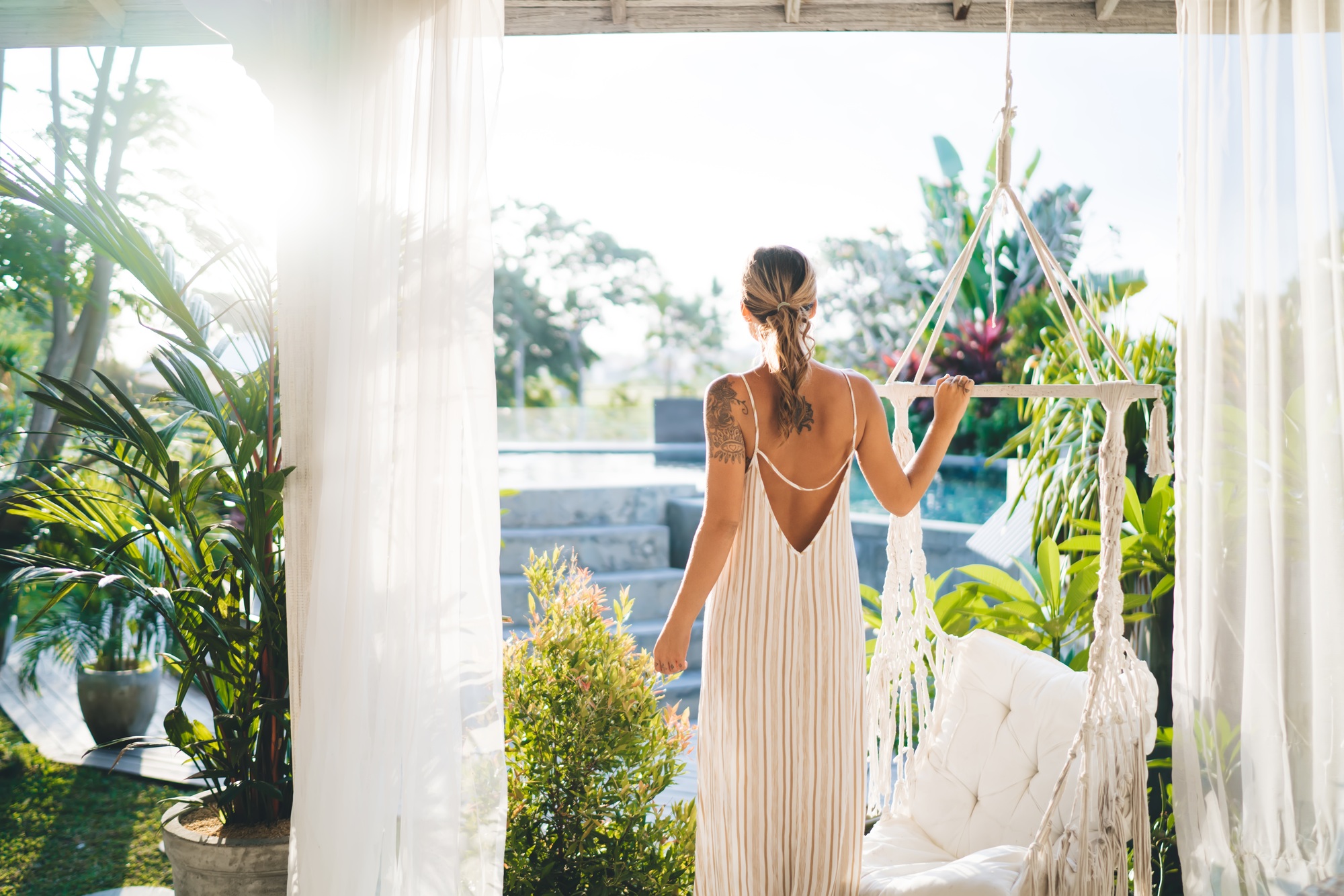 Back of young woman on terrace of resort hotel