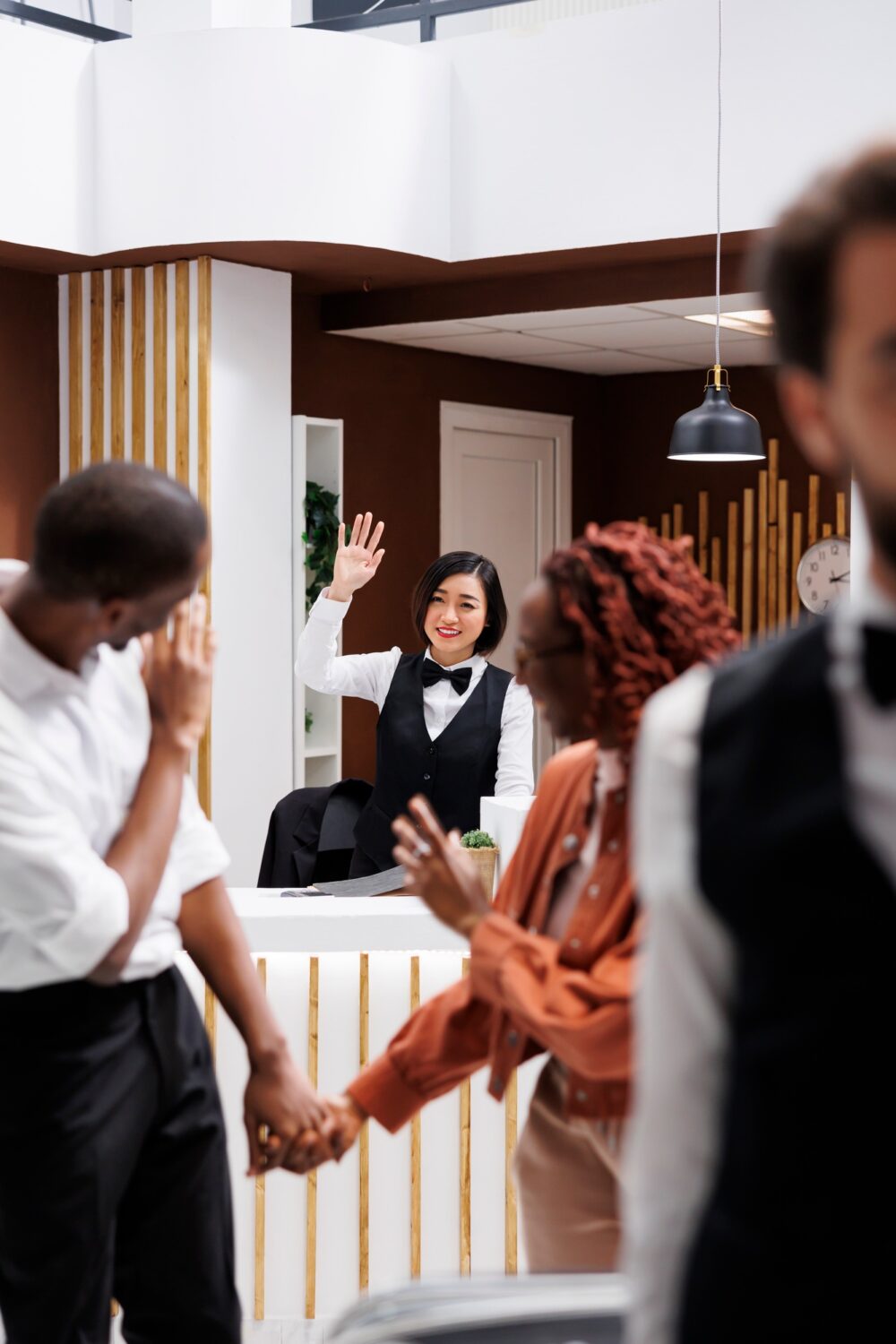 Couple saying goodbye to hotel employee