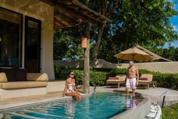 couple men and women on a luxury vacation at a pool villa