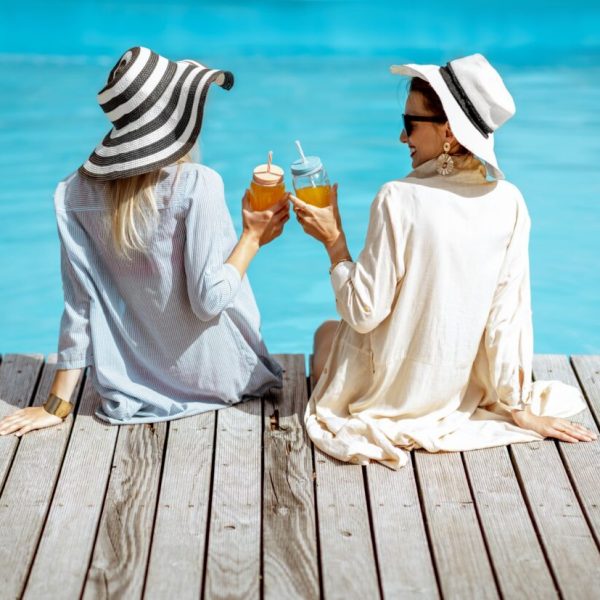 Girlfriends on the swimming pool outdoors