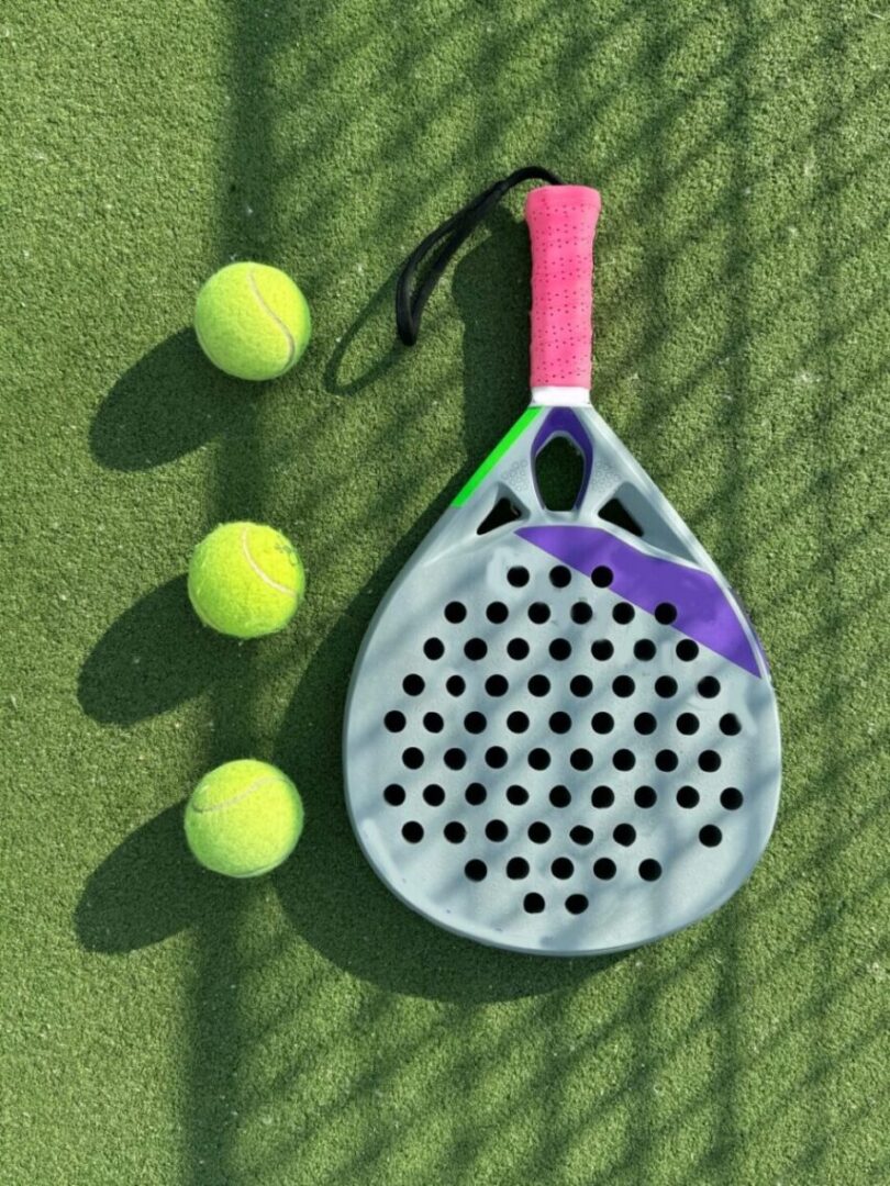 paddle tennis racket and balls on court