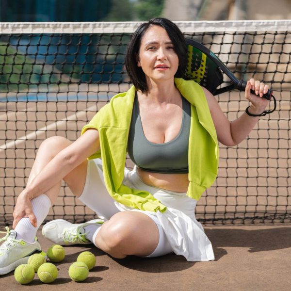 Woman padel player posing on outdoor court