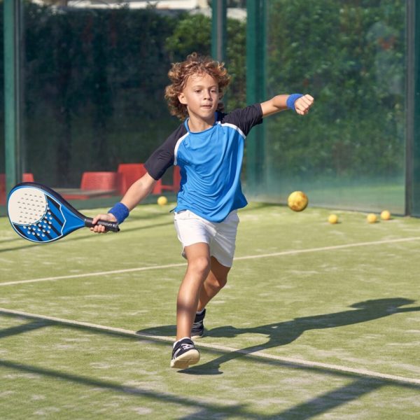 Boy playing padel on court